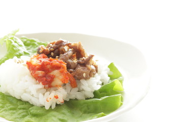 Korean food, grilled beef and kimchi on rice wrapped by lettuce