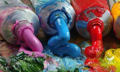 tubes with art oil paint on a palette. colorful art paints close-up
