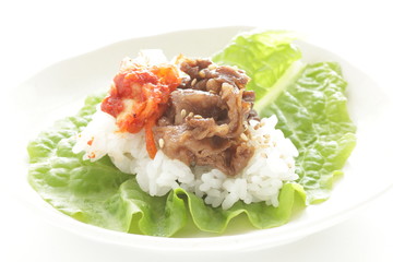 Korean food, grilled beef and kimchi on rice wrapped by lettuce