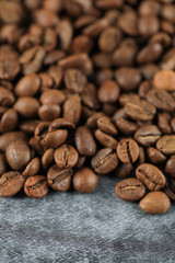 Fresh brown coffee beans on the top of the background