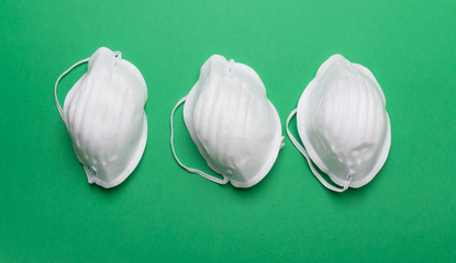 Anti coronavirus Covid-19 protective masks on green background
