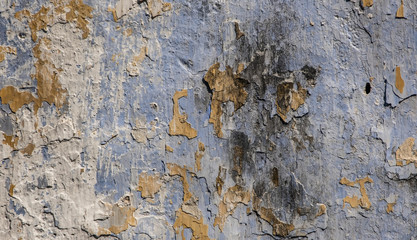 Old weathered wall with peeled off paint surface.
