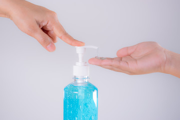 close-up mother's hand and boy applying sanitizer gel on hands anti coronavirus or covid-19 in studio on white background. Protective covid-19 outbreak concept.