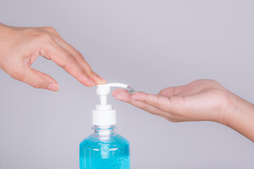 close-up mother's hand and boy applying sanitizer gel on hands anti coronavirus or covid-19 in studio on white background. Protective covid-19 outbreak concept.