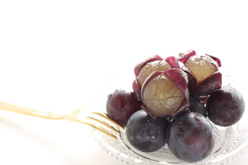 peeled Japanese grape on dish with copy space