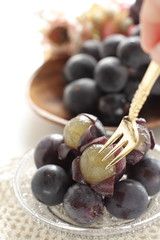 peeled Japanese grape on dish with copy space