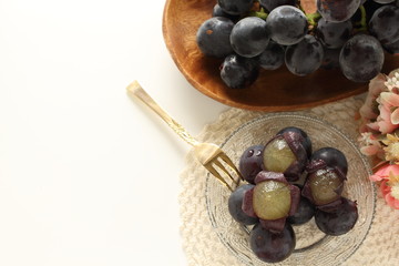 peeled Japanese grape on dish with copy space