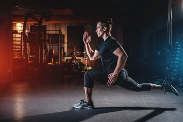 young man has crossfit workout with roller and weight in gym