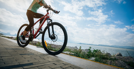 Fototapeta na wymiar Cyclist riding mountain bike on the coast trail