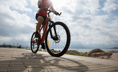 Cyclist riding mountain bike on the coast trail