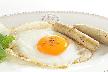 Gourmet breakfast, sunny side up fried egg and sausage