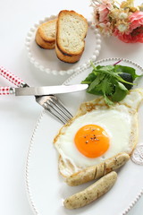 Gourmet breakfast, sunny side up fried egg and sausage