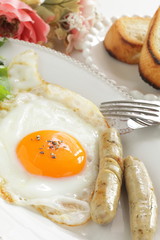 Gourmet breakfast, sunny side up fried egg and sausage