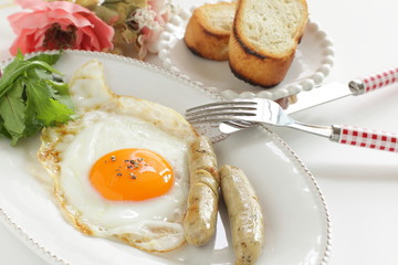 Gourmet breakfast, sunny side up fried egg and sausage