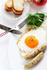 Gourmet breakfast, sunny side up fried egg and sausage