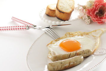 Gourmet breakfast, sunny side up fried egg and sausage