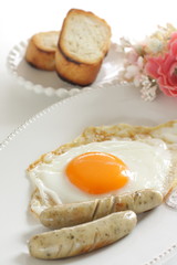 Gourmet breakfast, sunny side up fried egg and sausage