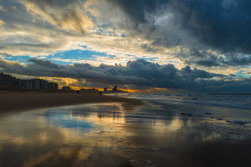 Sunset along the beach of Oostende (Ostend in English) during a thunder storm by the North Sea, West Flanders, Belgium.