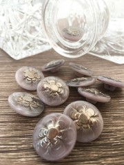 Fototapeta na wymiar czech glass flower buttons in lavender color