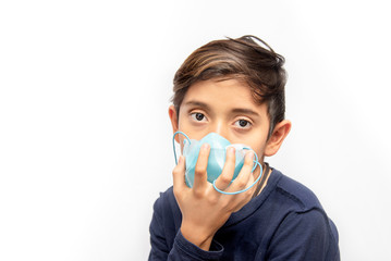 Latino boy with blue mask taking care of his health and avoiding the coronavirus pandemic