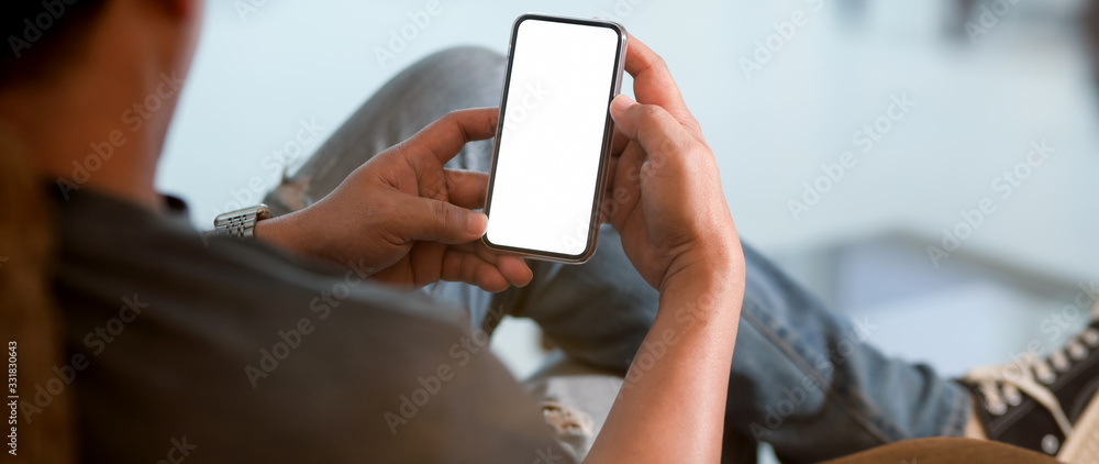 Poster close up view of a man using blank screen smartphone