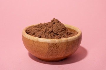 full wooden bowl of cocoa powder