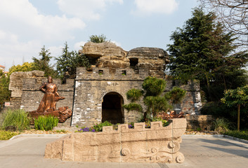 Rebuilt city wall & gate in Jiangwan Park at historic, old-town Jiangwanzhen, Hongkou, with sculpture of Han shizhong, patriotic general in Song dynasty & his poem.