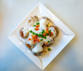 Momos Covered in Cheese and Peppers