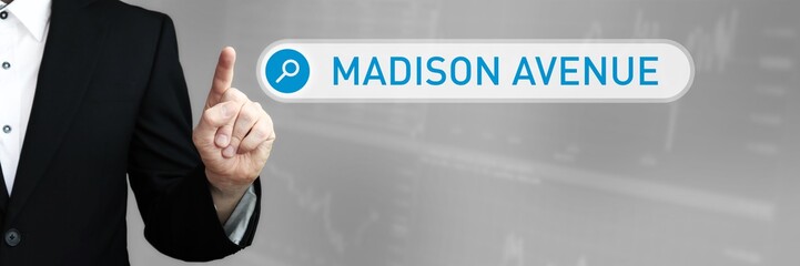 Madison Avenue. Man in a suit points a finger at a search box. The word Madison Avenue is in the search. Symbol for business, finance, statistics, analysis, economy