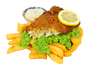 Beer battered fish and chips meal with mushy peas isolated on a white background