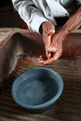 Coronavirus prevention, covid 19 in rural Guatemala, man washing hands, drinking water in El Progreso.