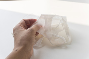 Hand with a used mask. protect from virus.