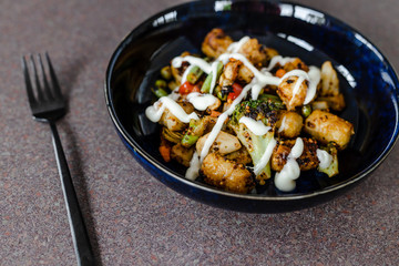 plant-based food, mixed grilled veggies with potato croquettes and veganaise topping