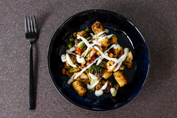 plant-based food, mixed grilled veggies with potato croquettes and veganaise topping