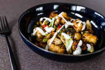 plant-based food, mixed grilled veggies with potato croquettes and veganaise topping