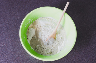 healthy homemade food,  preparing homemade herbs and sesame bread by mixing the ingredients in a bowl