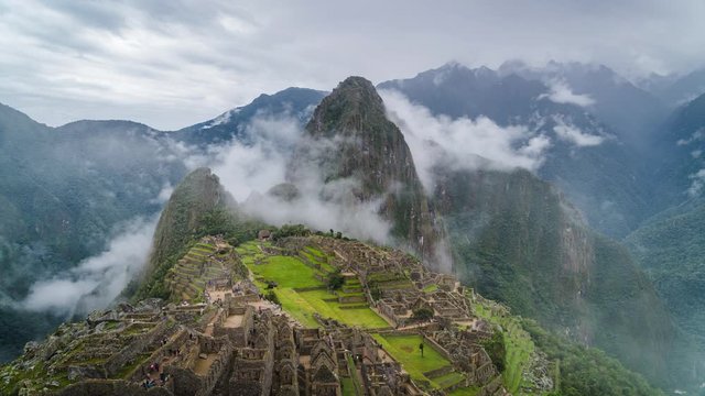 Time lapse view of mysterious Inca ruins of Machu Picchu shrouded in mist high in the Andes mountain range, Cusco Region, Peru.