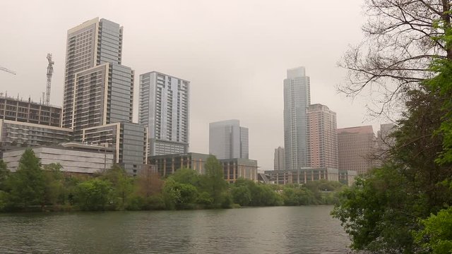 Austin Texas urban city landscape establishing shot. Colorado River in the foreground.