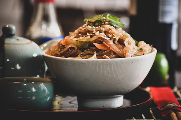 Sweet potato noodles fried with chicken and vegetables.