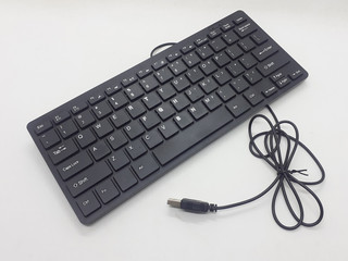 Small Minimalist Black Electronic Portable Keyboard for Computer Accessories Tools in White Isolated Background