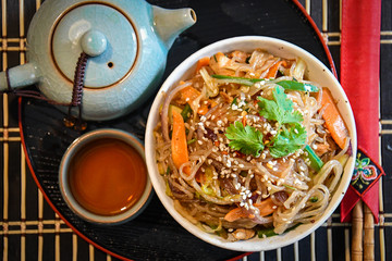 Sweet potato noodles fried with chicken and vegetables.