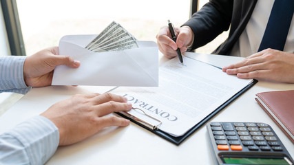 Bribery and corruption, Businessman hand giving money and receive in the envelope offered file Dishonest cheating in business illegal money concept.