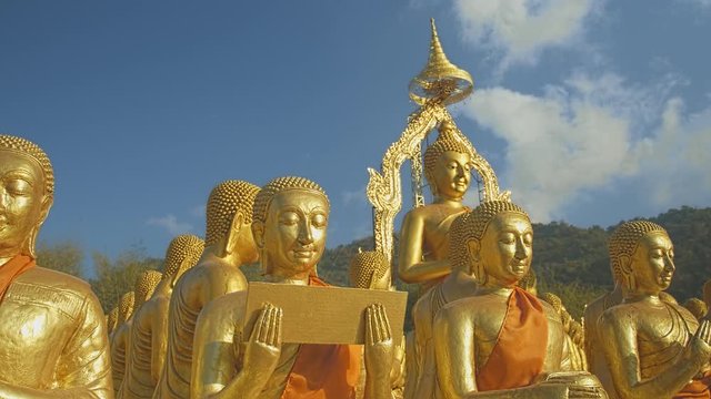 golden Buddha sculpture and disciples sculpture Makha bucha buddhist memorial park is built on the occasion of great period, buddha 2600 years at Nakornnayok province..