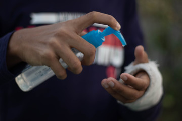 Close up view of using small portable antibacterial hand sanitizer on hands.Using hand sanitizer,antibacterial gel to wash hands and disinfect from covid-19 coronavirus