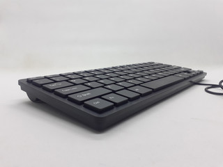 Small Minimalist Black Electronic Portable Keyboard for Computer Accessories Tools in White Isolated Background
