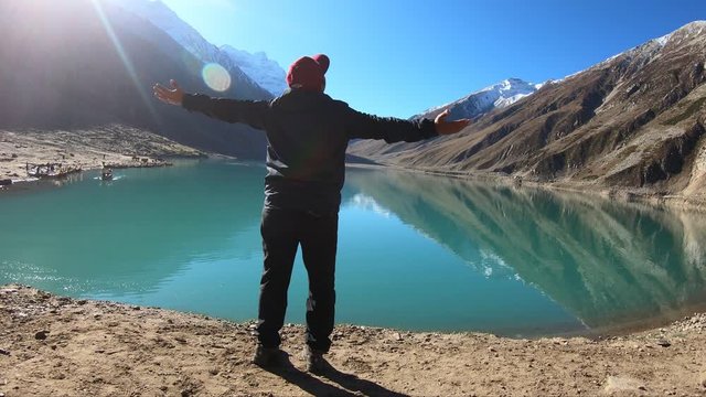 Traveler Trekker enjoying with open arms at Lake Saiful Malook Naran Valley KPK Mansehra Pakistan
