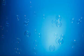 soap bubbles in air with  float on blue background