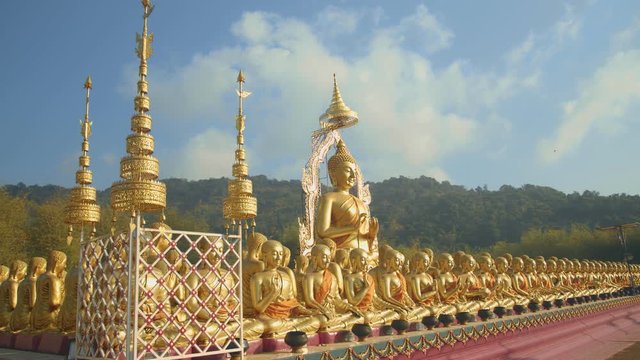 golden Buddha sculpture and disciples sculpture Makha bucha buddhist memorial park is built on the occasion of great period, buddha 2600 years at Nakornnayok province..