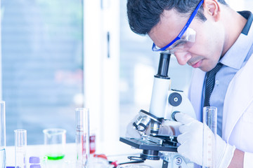 Young scientists biologists or researchers putting personal protective equipments to prevent...