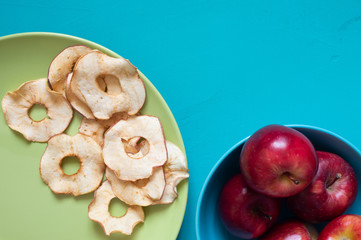 Dried and fresh red apples top view copy space on blue background